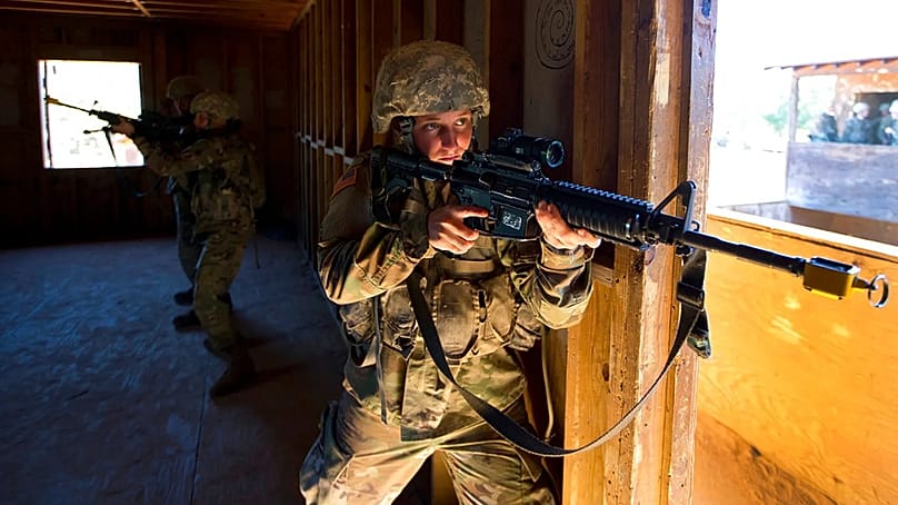 A female U.S. Army recruit practices building clearing tactics with male recruits at Ft. Benning, Ga., Oct. 4, 2017