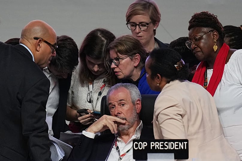 COP30 President André Corrêa do Lago sits as UN officials talk over him during a plenary session at the UN Climate Summit in Belem.