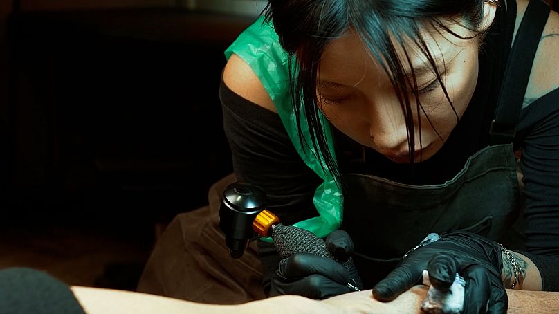Gui He, tattoo artist.