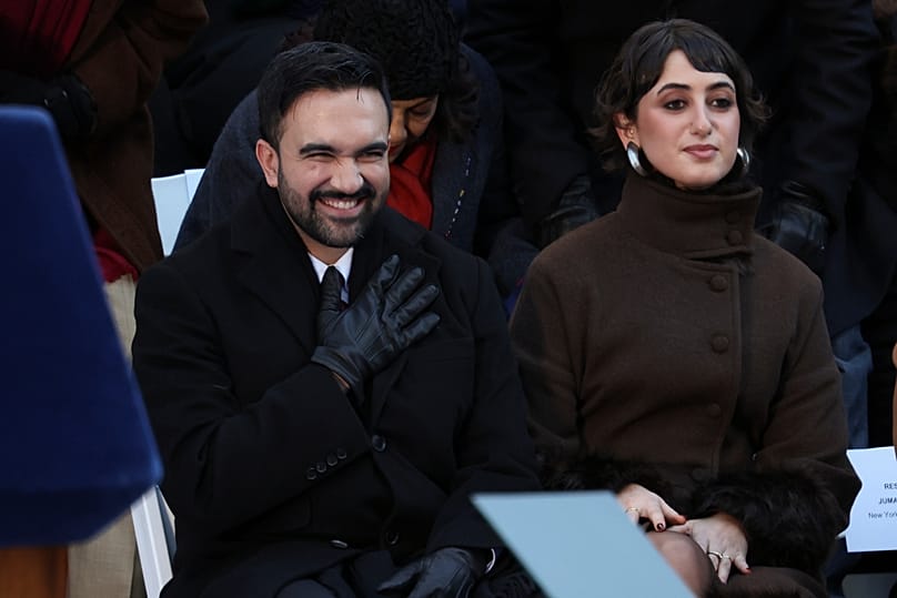 Mayor Zohran Mamdani reacts after arriving for his swearing-in ceremony as Rama Duwaji looks on, Thursday, Jan. 1, 2026, in New York