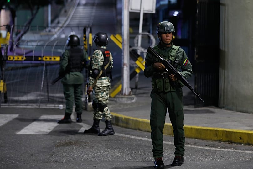 Soldiers guard the area around the Miraflores presidential palace after explosions and low-flying aircraft were heard in Caracas, Venezuela, Saturday, Jan. 3, 2026.