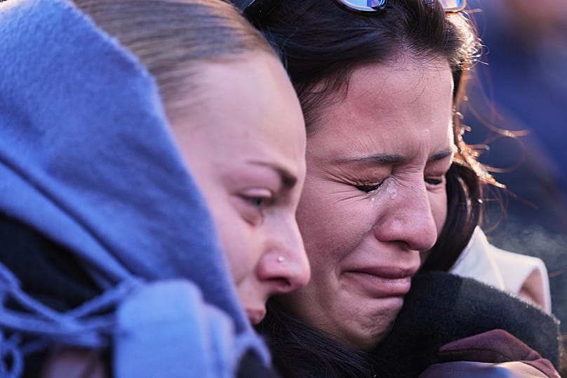 People mourn during a memorial procession after a devastating fire in Le Constellation bar killed 40 people, Crans-Montana, Swiss Alps, Switzerland, Sunday, Jan. 4, 2026
