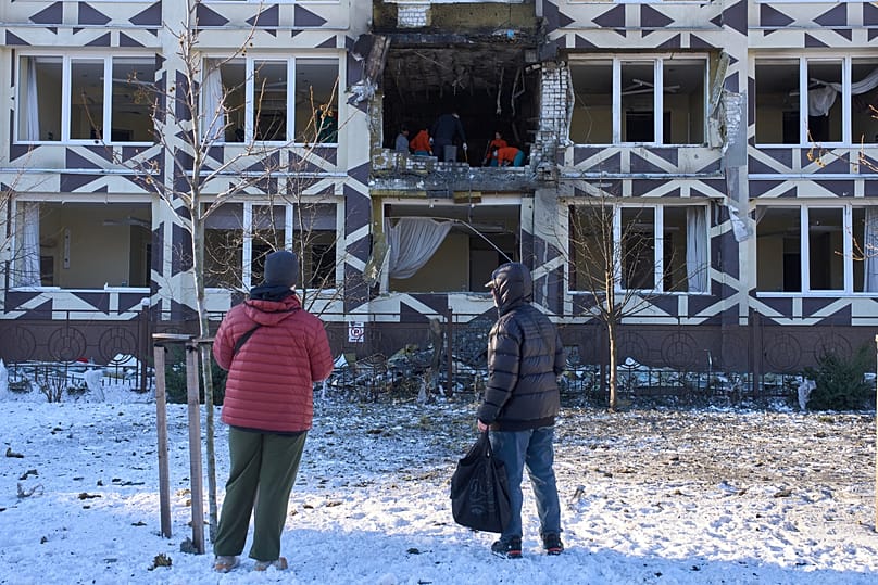 People look at a damaged private clinic after a Russian drone hit a hospital room killing a patient in Kyiv, 5 January, 2026