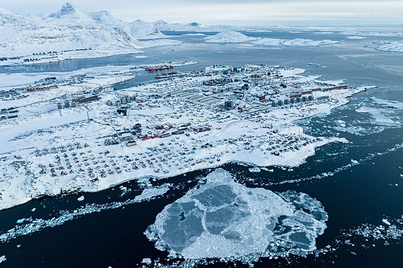 Houses covered by snow are seen on the coast of a sea inlet of Nuuk, Greenland, 7 March 2025