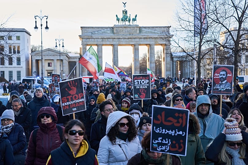 Protesters participate in a demonstration in front of the Brandenburg Gate in Berlin, 11 January, 2026