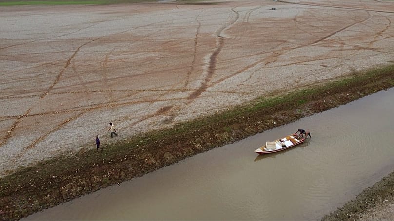 FILE - Fishermen push a boat in the Aleixo Lake amid a drought in Manaus, Amazonas state, Brazil, Sept. 24, 2024.