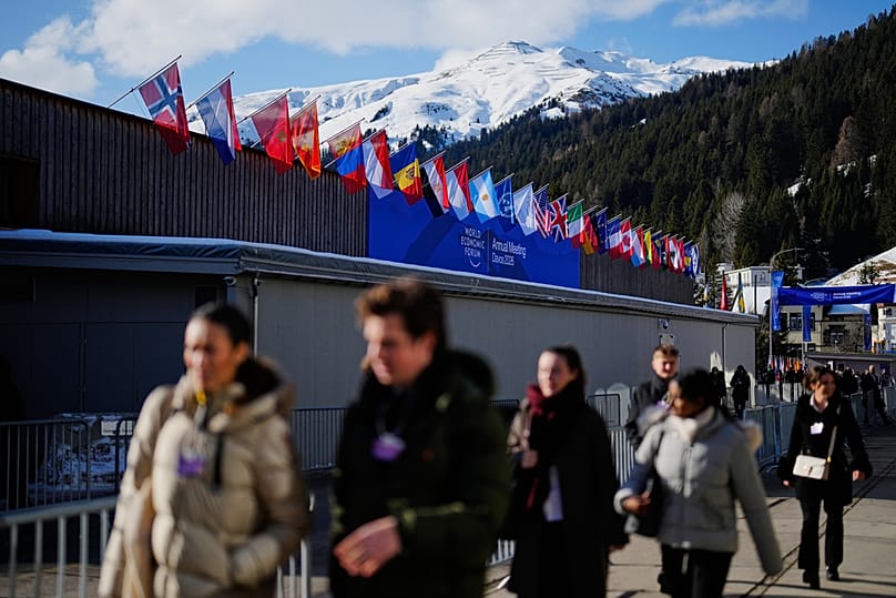 People walk at the Promenade in front of the Congress Center where the Annual Meeting of the World Economy Forum take place in Davos, 19 January 2026