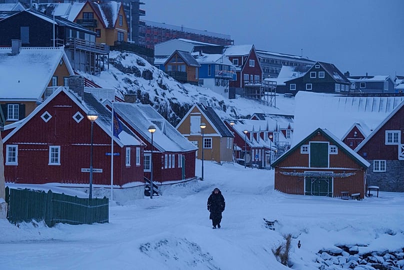 A person walks through a snow covered street in Nuuk, Greenland, 19 January 2026