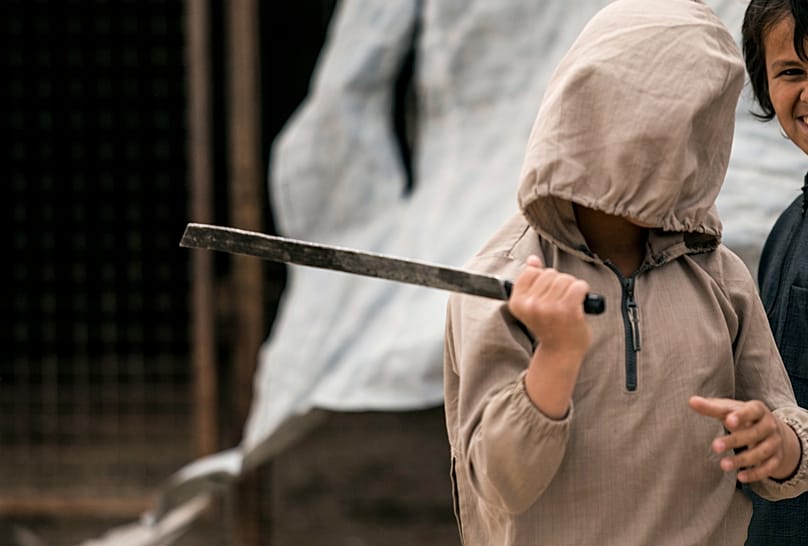 A boy plays with a broken sword at the al-Hol camp, which houses families of members of the terrorist organization “Islamic State,” in al-Hasaka province.