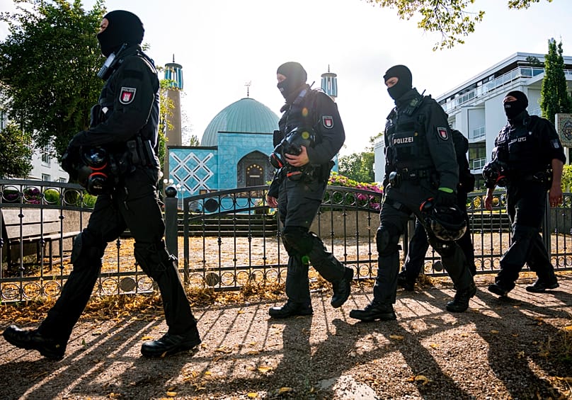 Police officers walk along the Outer Alster on Wednesday, July 24, 2024, during a raid on the grounds of the Islamic Center Hamburg (IZH).