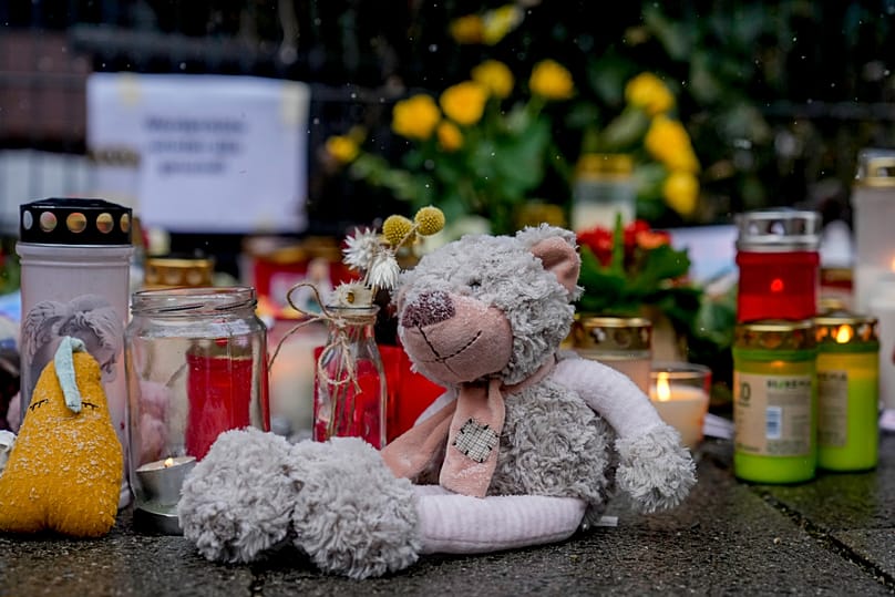 Flowers, candles, and a teddy bear were laid near the site where a car drove into a group of demonstrators – February 16, 2025.