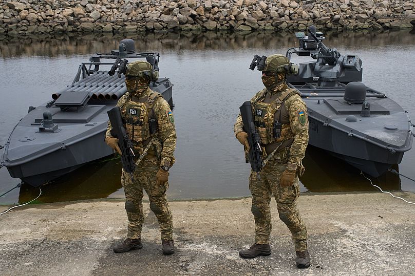 Ukraine's Security Service officers stand by Sea Baby drones, during a demonstration at an undisclosed location in Ukraine Friday, Oct. 17, 2025.