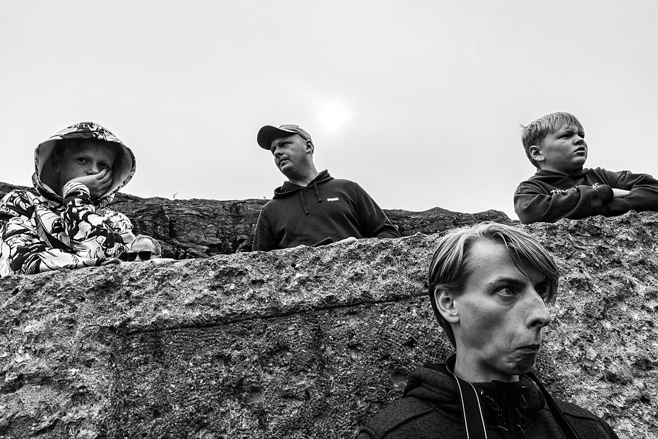 Between the Lines: A candid, comedic black-and-white photograph of a family at Ørnevegen, Norway.