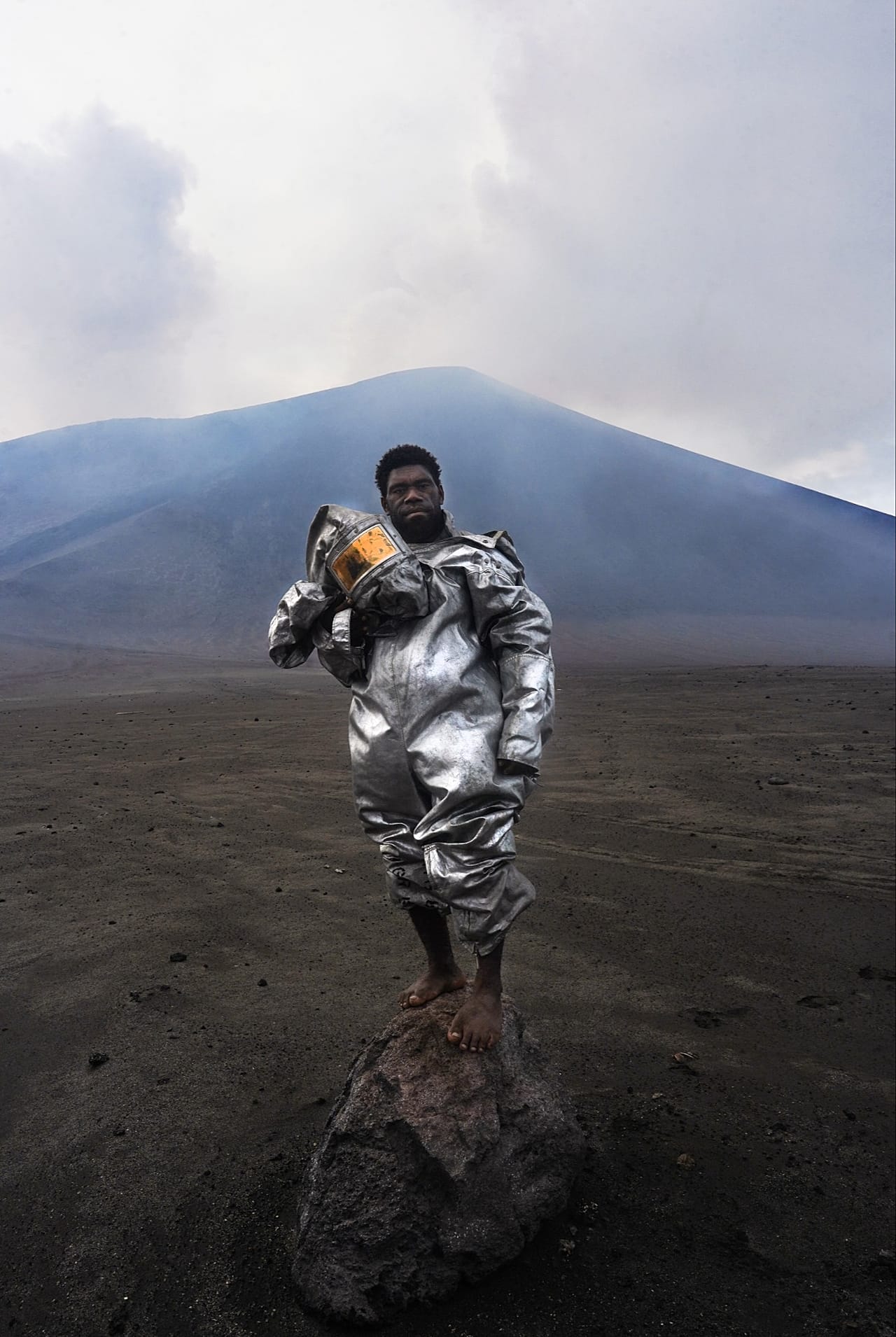 The Barefoot Volcanologist: A portrait of Phillip, an internationally recognised, self-taught volcano scientist, standing atop a volcanic rock