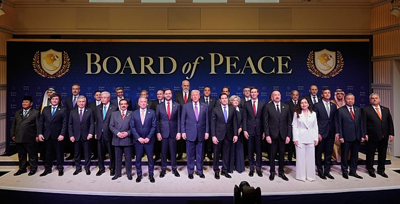 President Donald Trump stands with other World leaders before a Board of Peace meeting at the US Institute of Peace, Thursday, Feb. 19, 2026, in Washington.