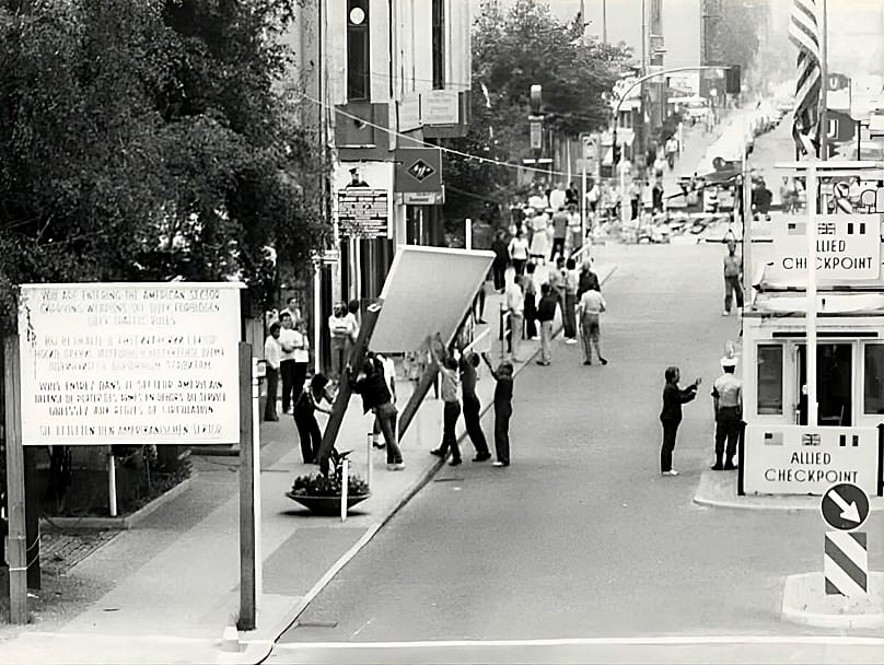 Members of the film crew put up a second sector sign
