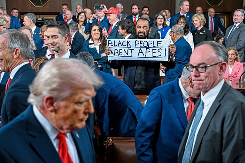 Al Green holds up a sign as President Donald J. Trump walks by on his way to deliver the State of the Union address at the U.S. Capitol in Washington, Tuesday, Feb. 24, 2026.