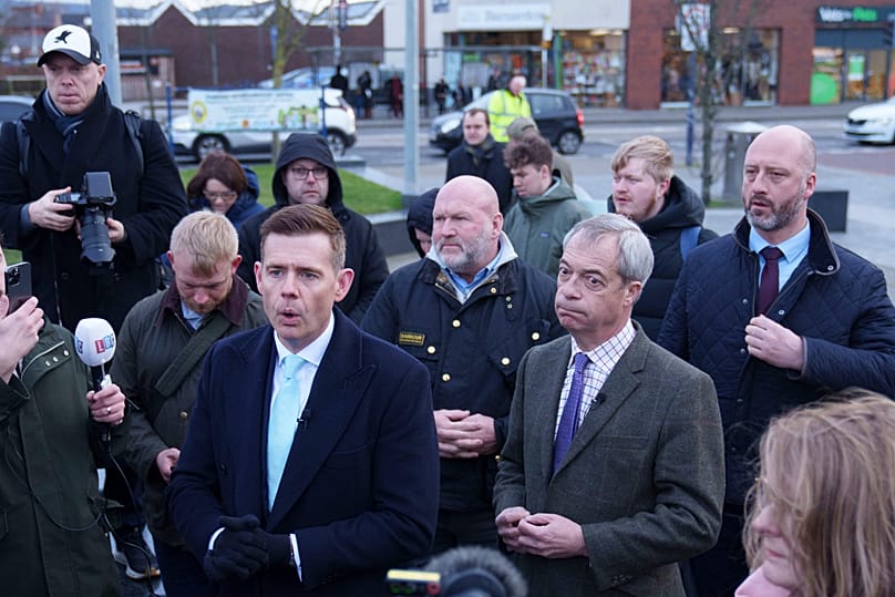 Reform UK's Matt Goodwin (centre) campaigns with party leader Nigel Farage.