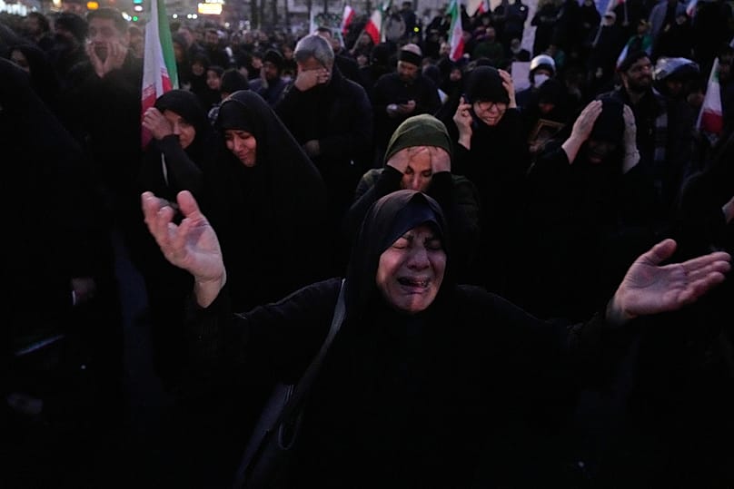 Government supporters mourn in a gathering after state TV officially announced the death of Iranian Supreme Leader Ayatollah Ali Khamenei, in Tehran, Iran, Sunday, March 1