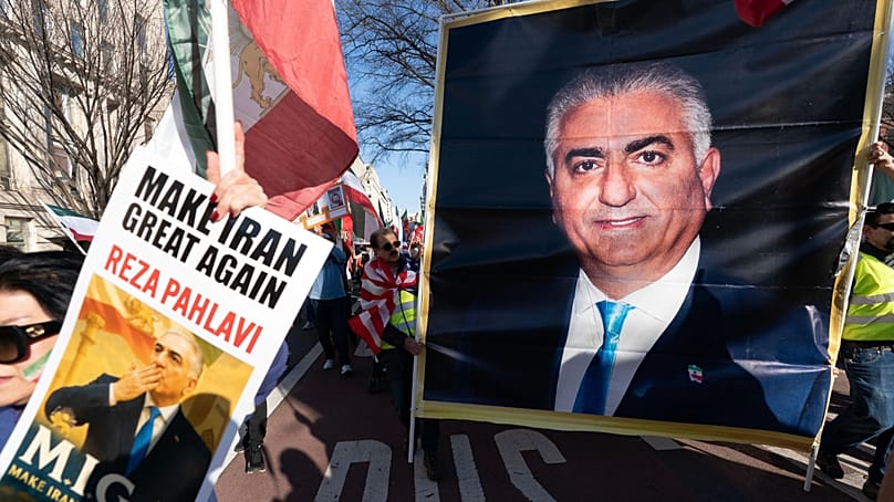 Demonstrators carry a photograph of Reza Pahlavi as people who support the U.S. and Israel strikes on Iran, rally near the White House, Saturday Feb. 28, 2026, in Washington.