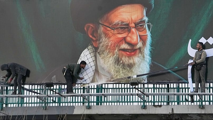 Workers install a billboard of the late Supreme Leader Ayatollah Ali Khamenei, who was killed during ongoing joint U.S.-Israeli military attacks, in Tehran, March 2, 2026.