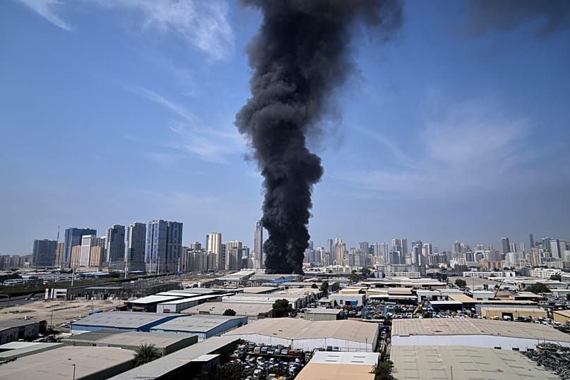 A black plume of smoke rises from a warehouse at the industrial area of Sharjah City in the United Arab Emirates, 1 March, 2026