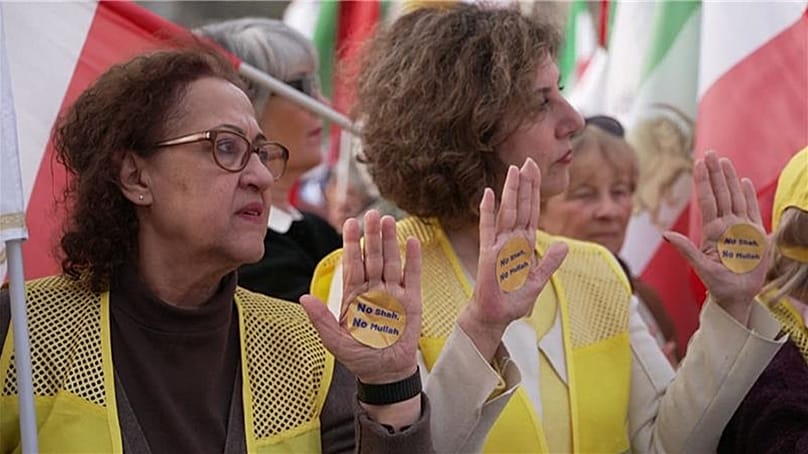 Protesters showing their palms with stickers on them reading “No Shah, No Mullah”, Paris, France, 7 March, 2026.