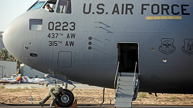 US soldiers from the 437th Airlift Wing inspect a C-17 Globemaster III prior to handover by Boeing at the factory in Long Beach, California, on 12 September 2013