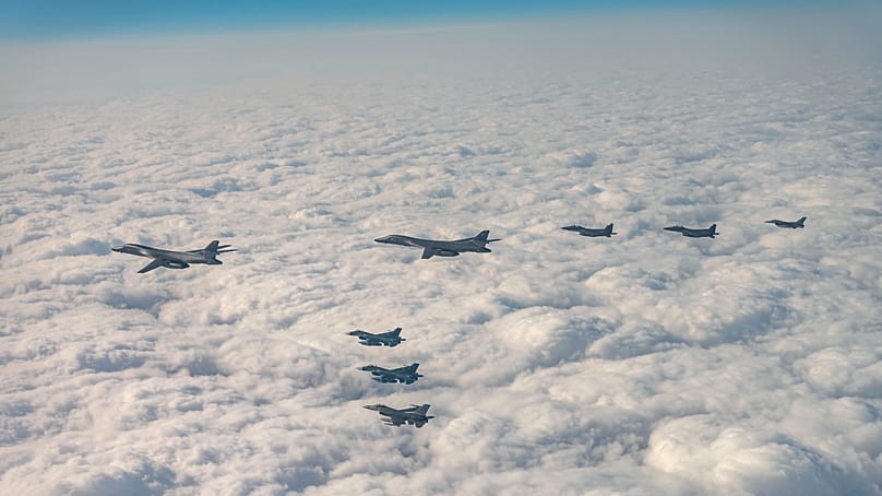 In this photo provided by South Korea's Defense Ministry, bombers and fighter jets from the US, South Korea and Japan fly over South Korea during a joint drill. (Via AP)