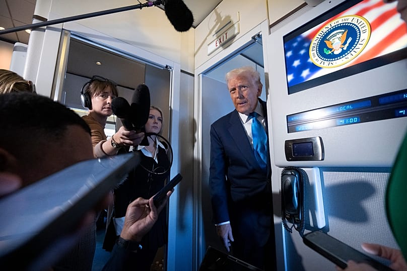 US President Donald Trump speaks to reporters aboard Air Force One as he travels from Tokyo to South Korea, Oct. 29, 2025. (AP Photo/Mark Schiefelbein)