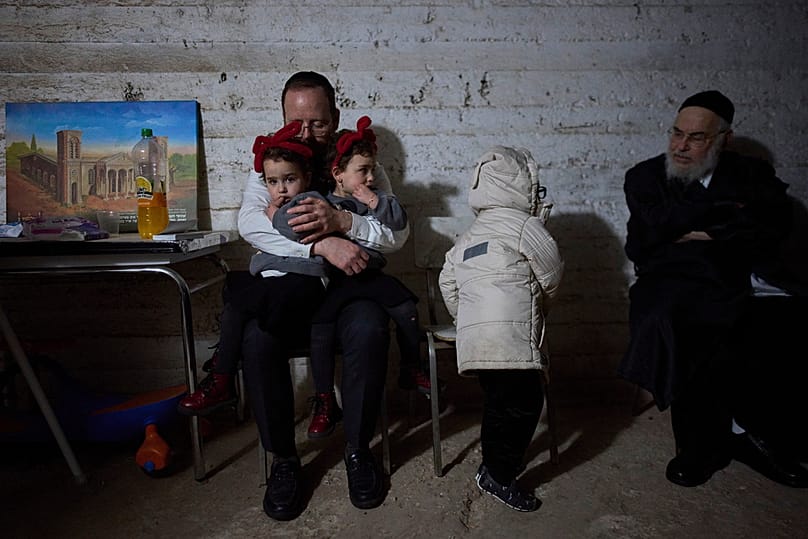People take cover in a bomb shelter as air raid sirens warn of incoming Iranian missile strikes in Bnei Brak, Israel, Wednesday, March 25, 2026