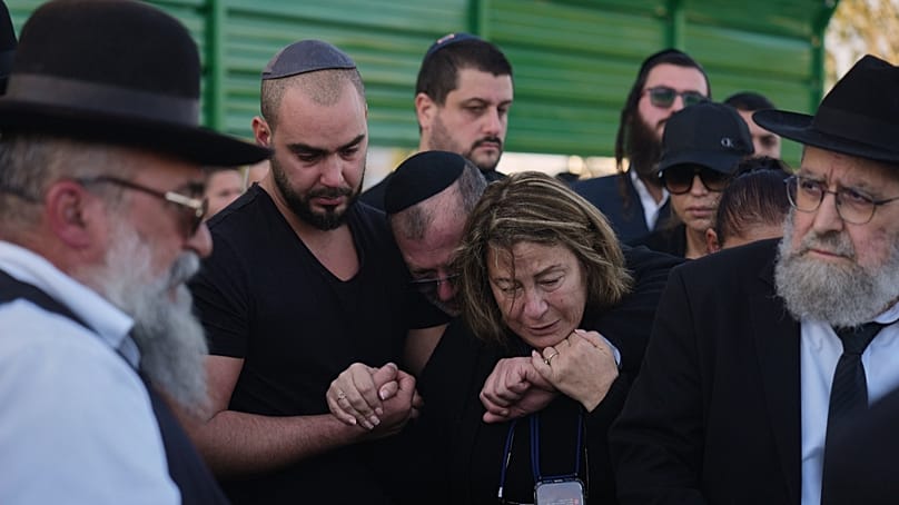 Annie, center, is comforted at the funeral of her son Dan Elkayam, killed in a mass shooting at a Hanukkah event in Sydney, Ashdod, Dec. 25, 2025