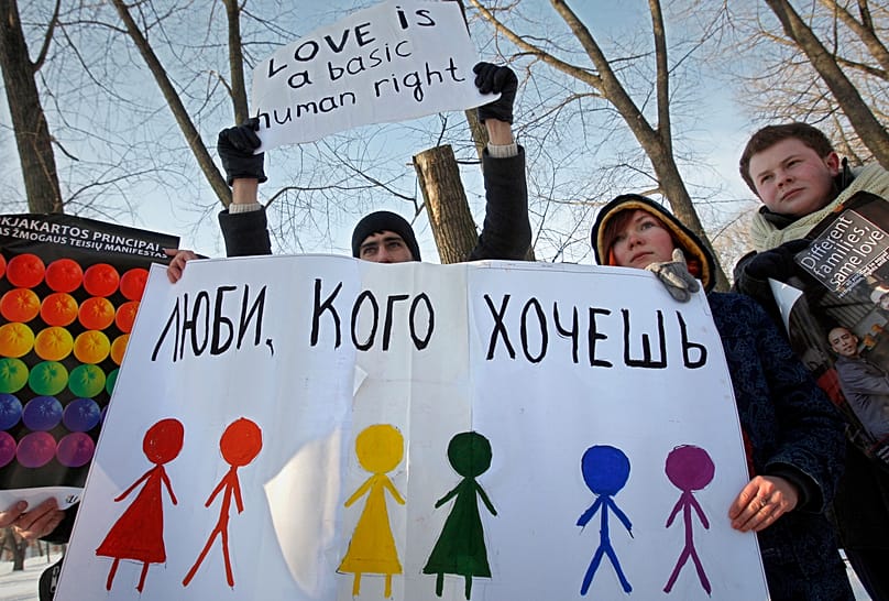 Activists hold placards during a picket against homophobia in front of the Department of Justice in Minsk, 14 February, 2010