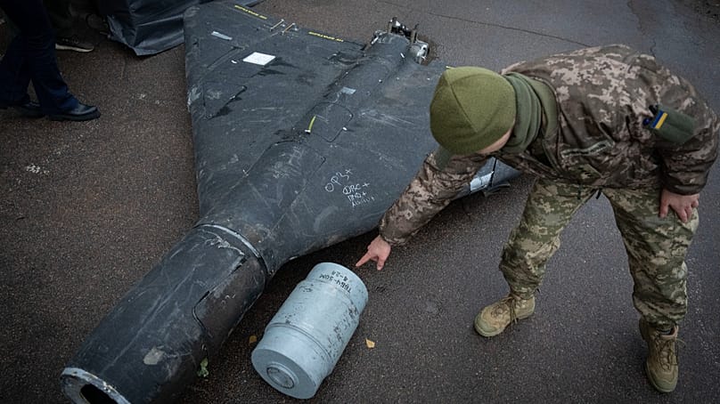 A Ukrainian officer shows a thermobaric charge of a downed Shahed drone launched by Russia in a research laboratory in an undisclosed location in Ukraine, Nov. 14, 2024