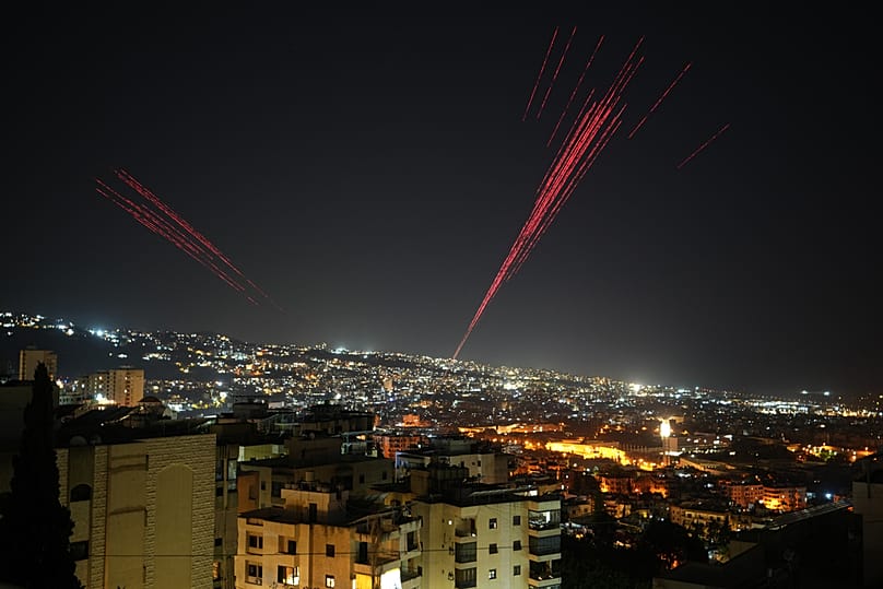 Tracer rounds illuminate the night sky as people celebrate the announcement of a ceasefire between Israel and Hezbollah, Beirut, Friday, April 17, 2026