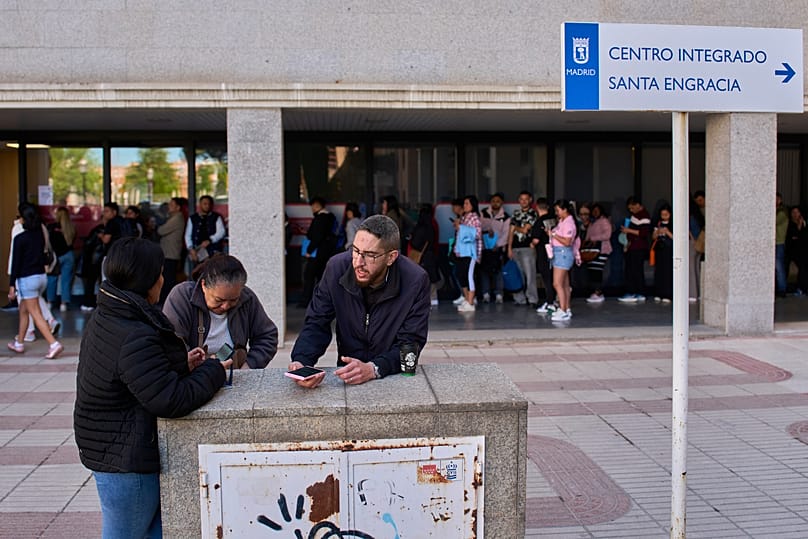 Immigrants queue to request public transport certificate in Madrid, 16 April, 2026