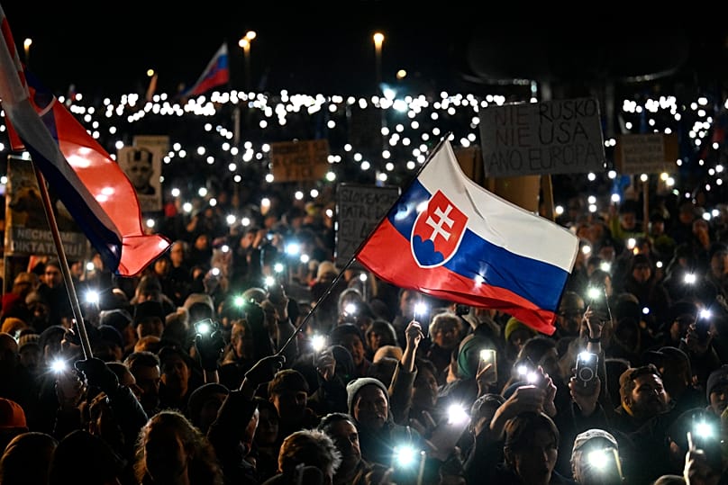 People light up their phones as thousands gather to oppose the policies of Prime Minister Robert Fico in Bratislava, 24 January, 2025