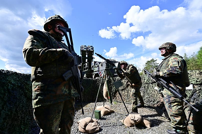 Soldiers from Homeland Security Regiment 3 stand next to a Patriot anti-aircraft missile system at the Münster military training area, 18 April, 2024