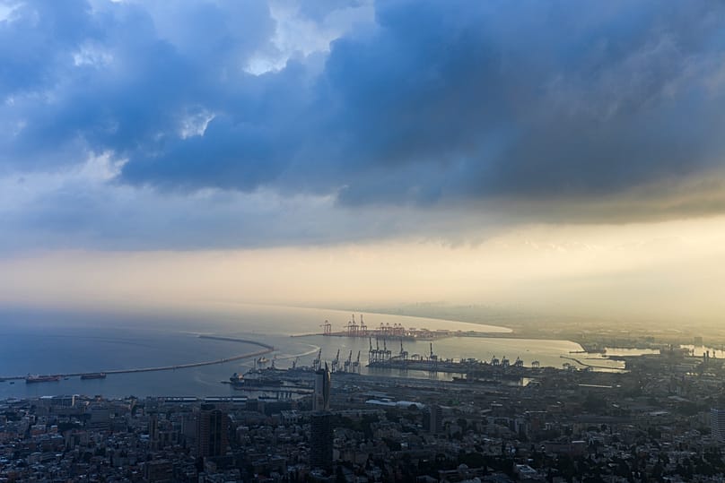 Ships are docked as the sun raises at the port of Haifa, 24 November, 2024