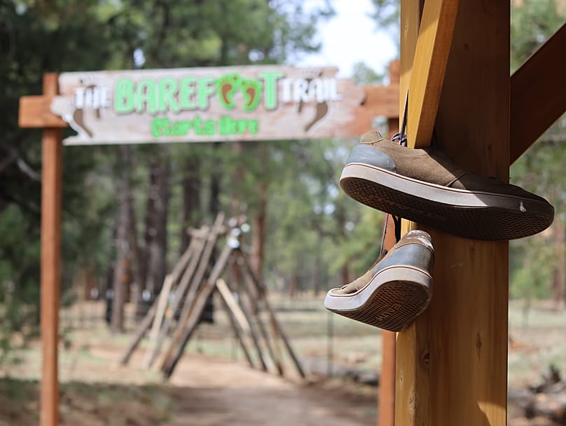 Shoes hang near the entrance of a barefoot trail near Flagstaff, Ariz, on Thursday, April 16, 2026.