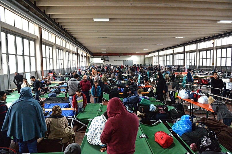 Refugees wait in a crowded migrant registration centre in Passau, 8 October, 2015