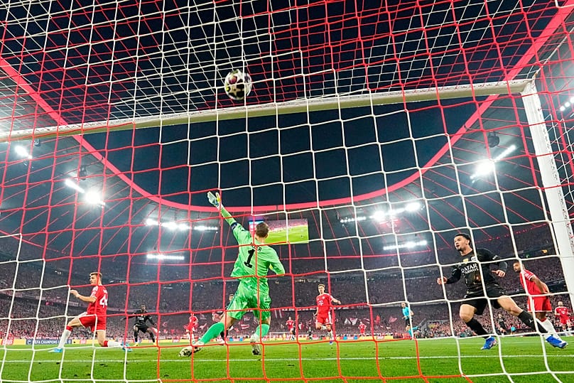 PSG's Ousmane Dembele, background left, scores the opening goal of his team during the Champions League semifinal second leg soccer match between Bayern Munich and Paris Saint