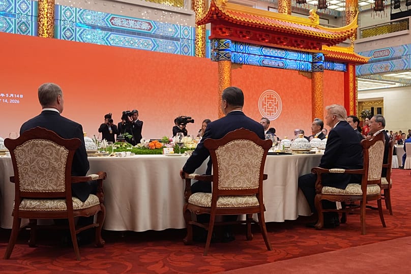 President Donald Trump, right, seats beside and Chinese President Xi Jinping, center, during a state dinner at the Great Hall of the People. (AP Photo/Mark Schiefelbein)