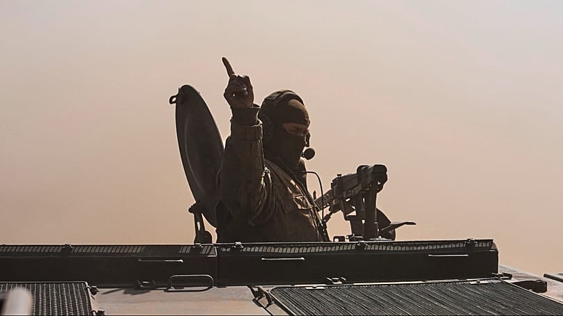 A commander sits in a battle vehicle Fuchs in the dust during a visit of Chancellor Friedrich Merz to the army at the Bundeswehr base in Munster, Germany, April, 30, 2026.