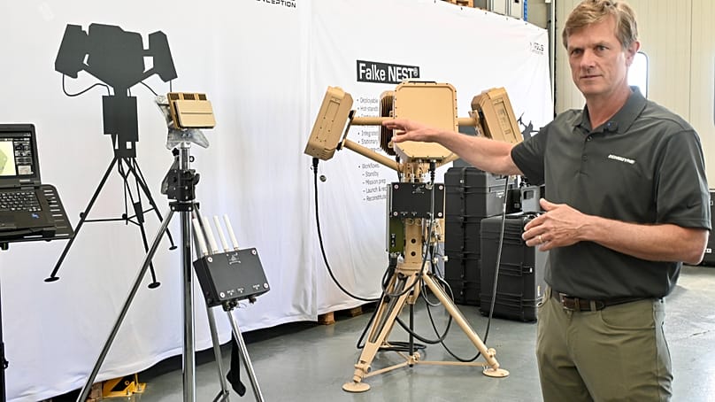 Echodyne CEO Eben Frankenberg next to a radar system.