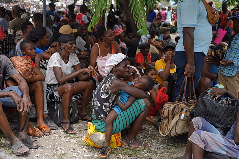People displaced from their homes due to clashes between armed gangs take refuge at a police station in Port-au-Prince, 11 May, 2026