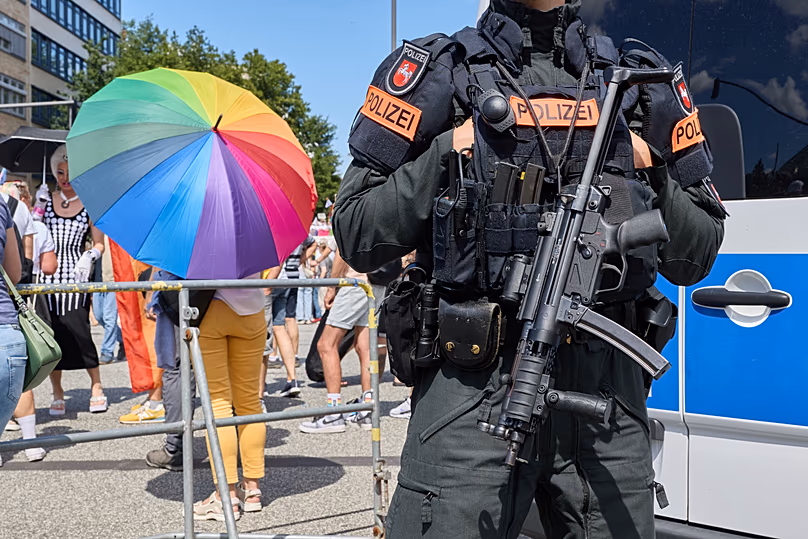 A police officer stands on Steindamm at the edge of Hamburg Pride 2026, the Christopher Street Day (CSD) parade, in Hamburg, Germany, Saturday Aug. 1, 2026.
