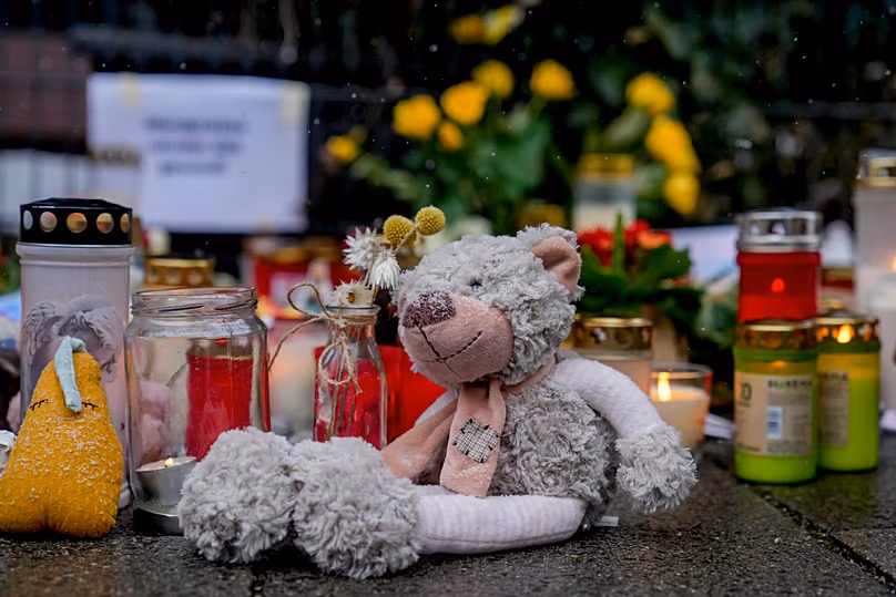 Flowers and candles and a teddy bear laid near the spot where a car drove into a group of protesters in Munich, 16 February, 2025