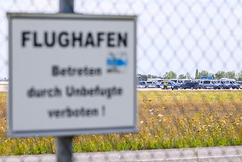 Police vehicles are parked along the north runway at Leipzig/Halle Airport, 6 August, 2026