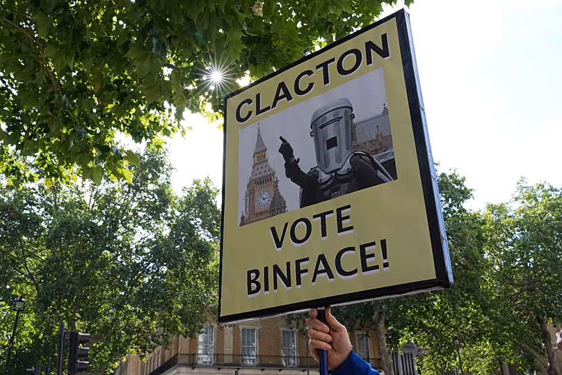 A protester holds a placard referring to the Clacton by-election outside the gates of Downing Street in London, 20 July, 2026